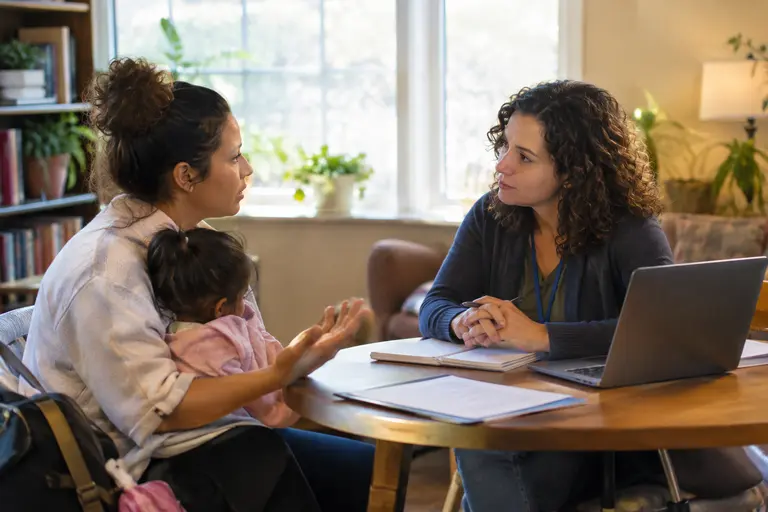Case manager helping a parent review apartment options